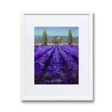 Farmhouse wall art of lavender fields landscape painting. The artwork is framed in a white wood frame and picture mat on a white wall.