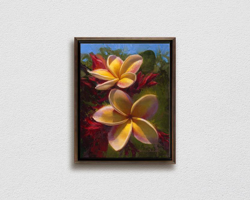 Framed wall art canvas of tropical Hawaiian Plumeria flowers painting by Hawaii artist Karen Whitworth on white wall