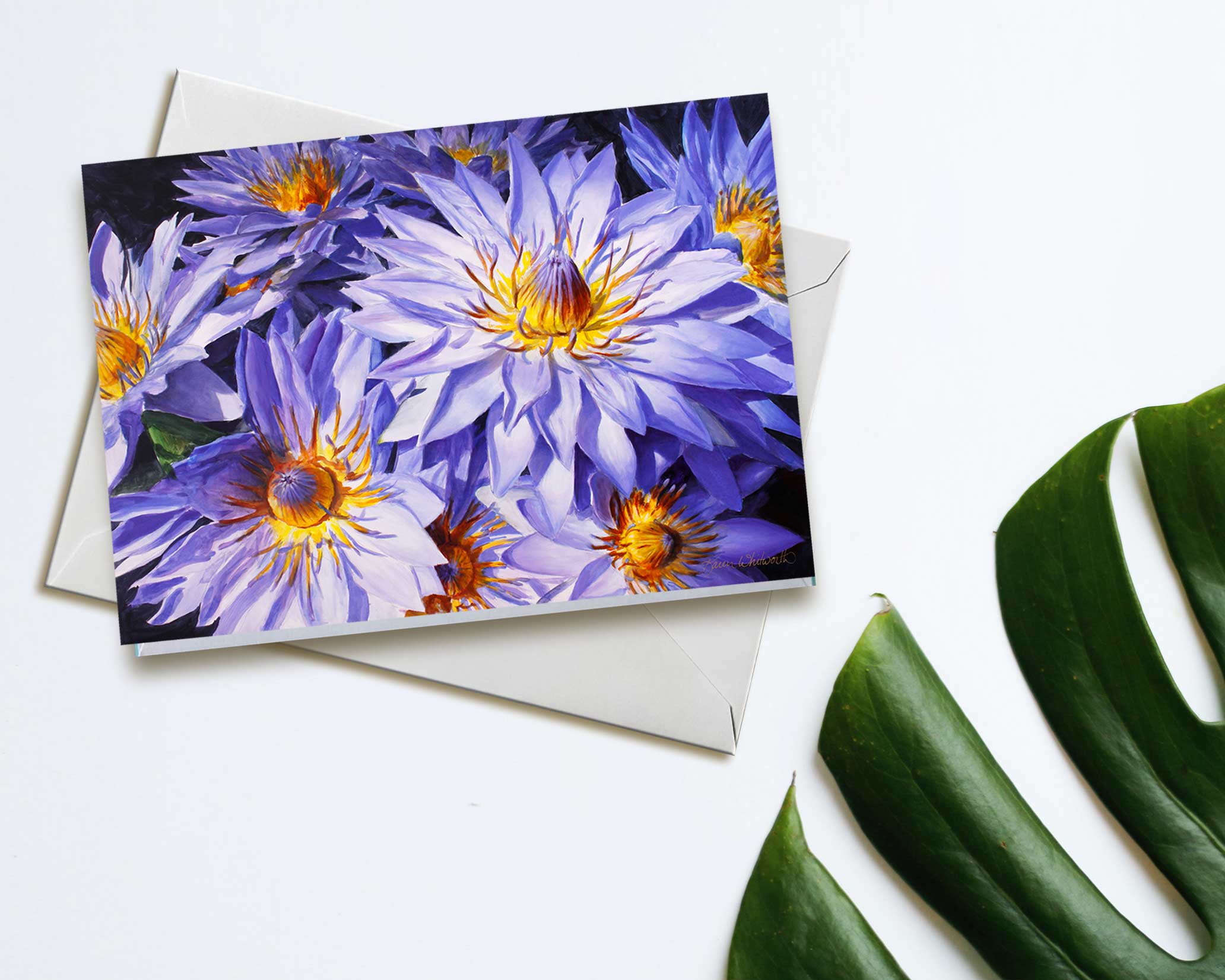 An envelope and card featuring art of tropical Hawaiian Lotus Flowers on white background