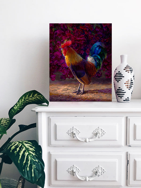 Tropical wall art painting of Kauai Rooster by Hawaii Gallery Artist Karen Whitworth sitting on white dresser with vase and potted house plant.