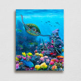 Ocean wall art canvas of green sea turtle swimming through a coral reef with tropical fish