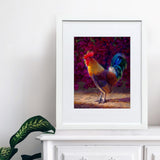 Rooster wall art print of a painting depicting a male chicken standing in front of a flowering bougainvillea bush. The rooster decor print is displayed next to a pineapple.