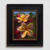 Framed wall art canvas of tropical Hawaiian Plumeria flowers painting by Hawaii artist Karen Whitworth on white wall