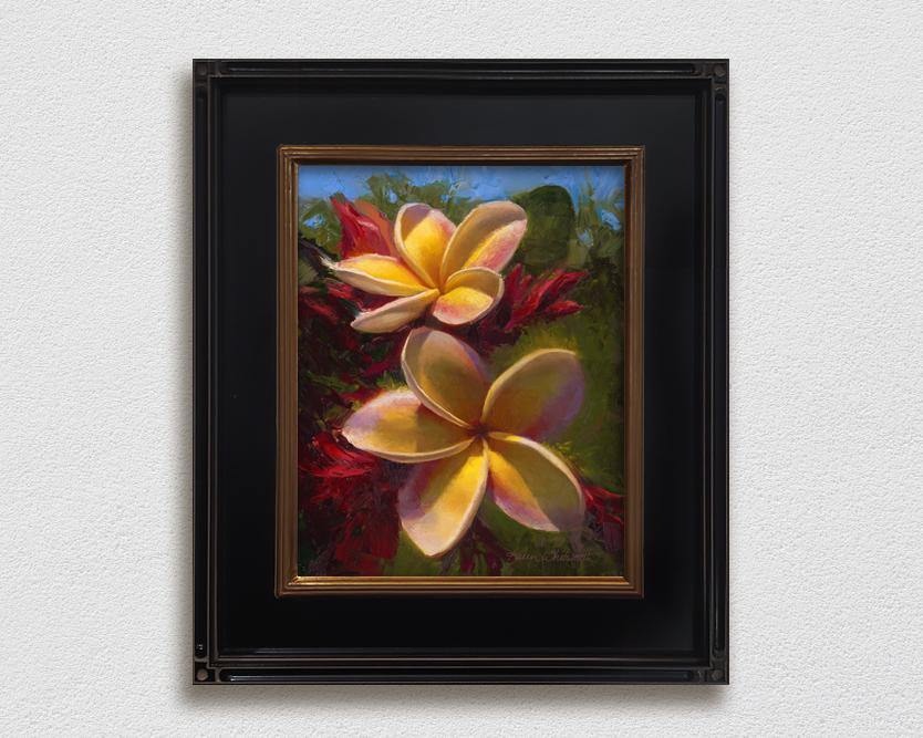 Framed wall art canvas of tropical Hawaiian Plumeria flowers painting by Hawaii artist Karen Whitworth on white wall