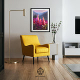 An Alaska wall art print of a mountain landscape painting hangs on the wall above a yellow chair in a living room. The artwork is a painting by Alaska artist Karen Whitworth.