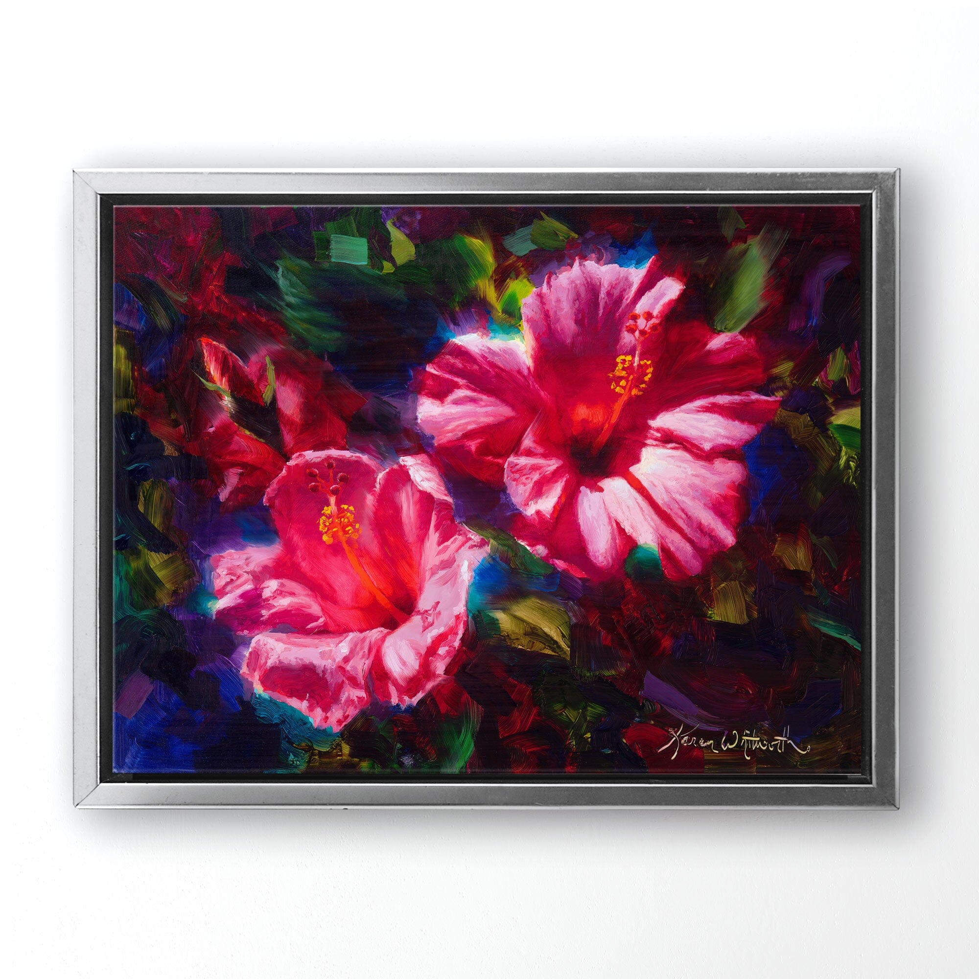 pink hibiscus Hawaiian flower painting on canvas by Hawaii artist Karen Whitworth. The artwork is framed in a silver frame and hanging on a white wall.