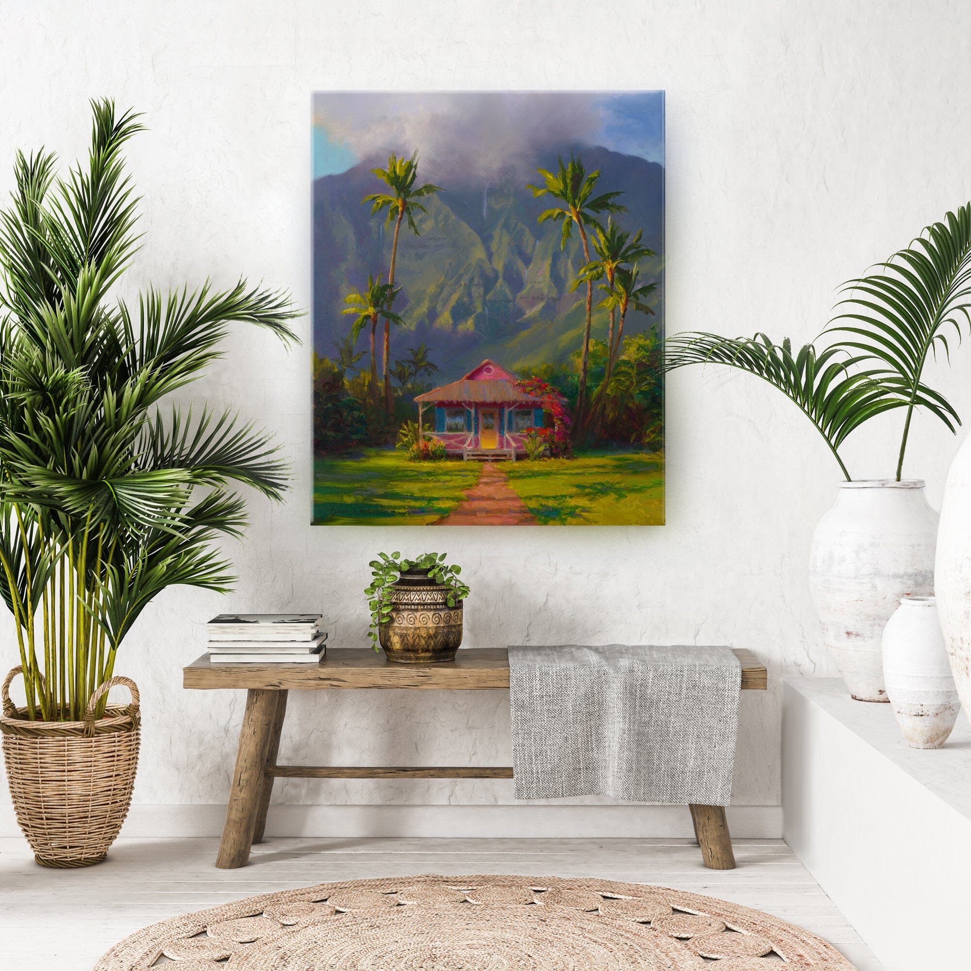 Hawaii landscape painting of a Hawaiian cottage beneath a tropical mountain and palm trees in Hanalei, Kauai. The painting is an original  artwork by artist Karen Whitworth and is depicted as a wall art hanging on a white wall.