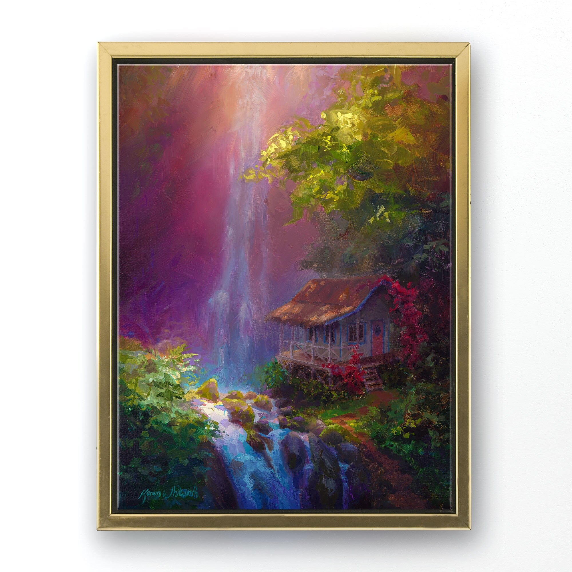 Landscape painting on canvas of Hawaiian waterfall by tropical artist Karen Whitworth titled "Healing Retreat". The canvas wall art is framed in a gold frame and is hanging on a white wall.