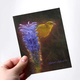 Person holding a Hawaii note card featuring painting of Amakihi Bird and Haleakala Lobelia Flower against a white background