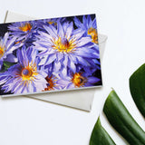 An envelope and card featuring art of tropical Hawaiian Lotus Flowers on white background