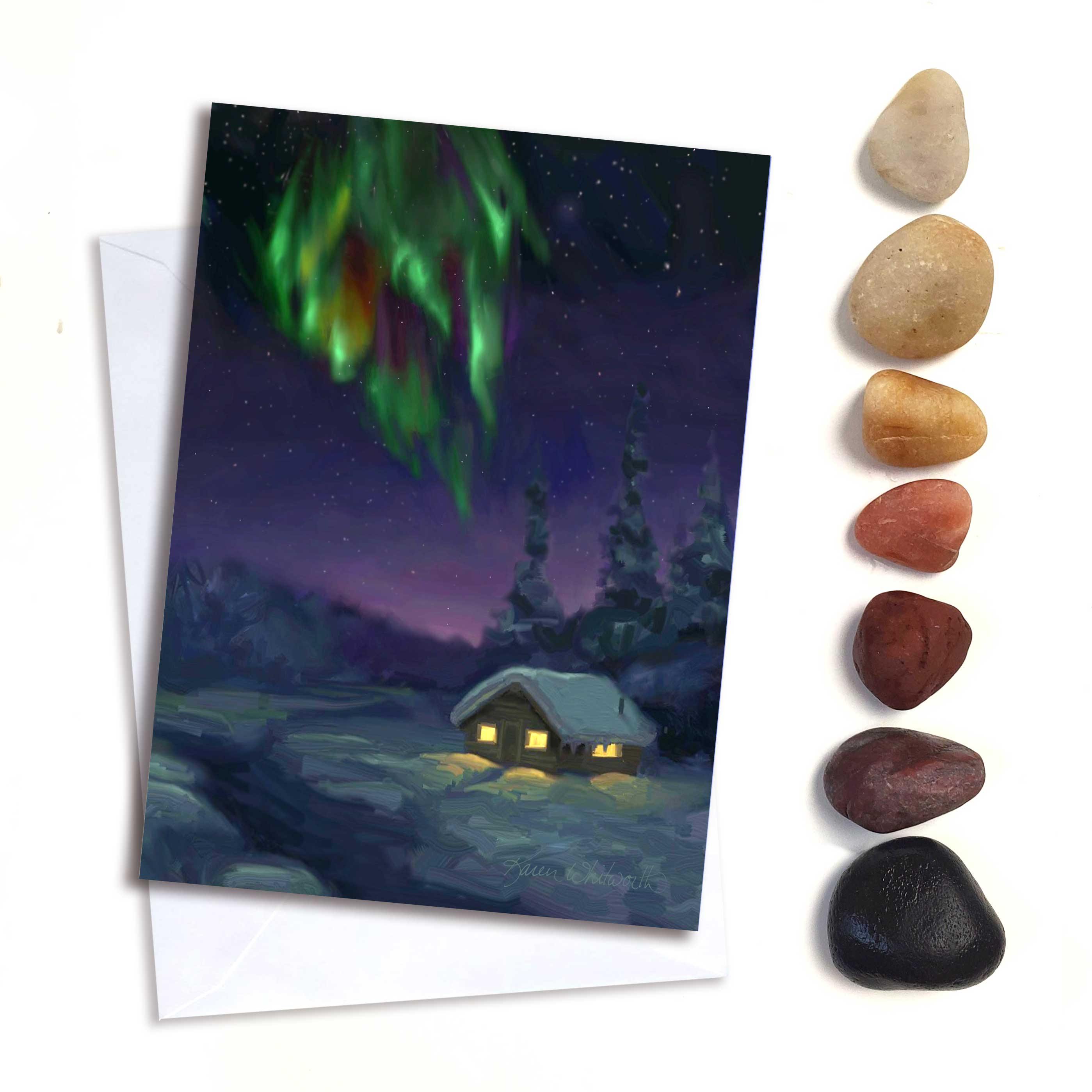 Northern lights greeting card with snowy log cabin by Alaska artist Karen Whitworth.